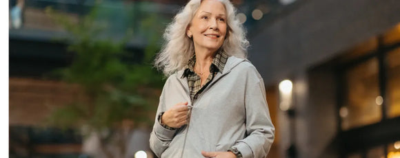 older woman wearing a zip up hoodie and flannel shirt from Joe & Bella
