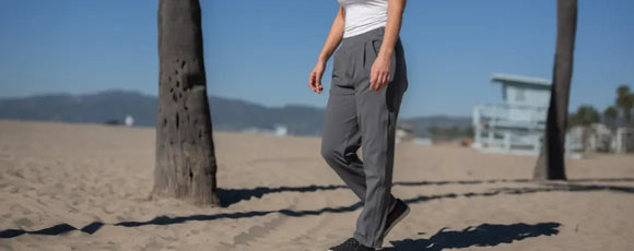 woman walking on beach while wearing Joe & Bella's adaptive pants with women
