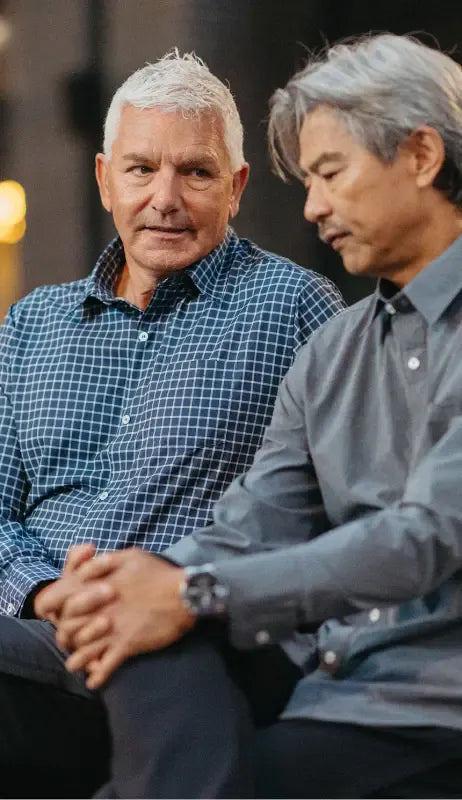 two men sitting on a bench wearing Joe  & Bella adaptive clothing for men