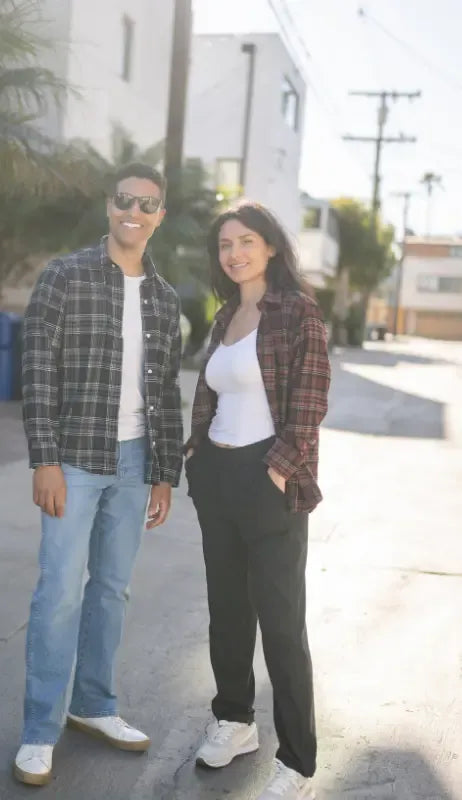 A man and woman are both wearing flannel shirts with magnetic buttons from Joe & Bella