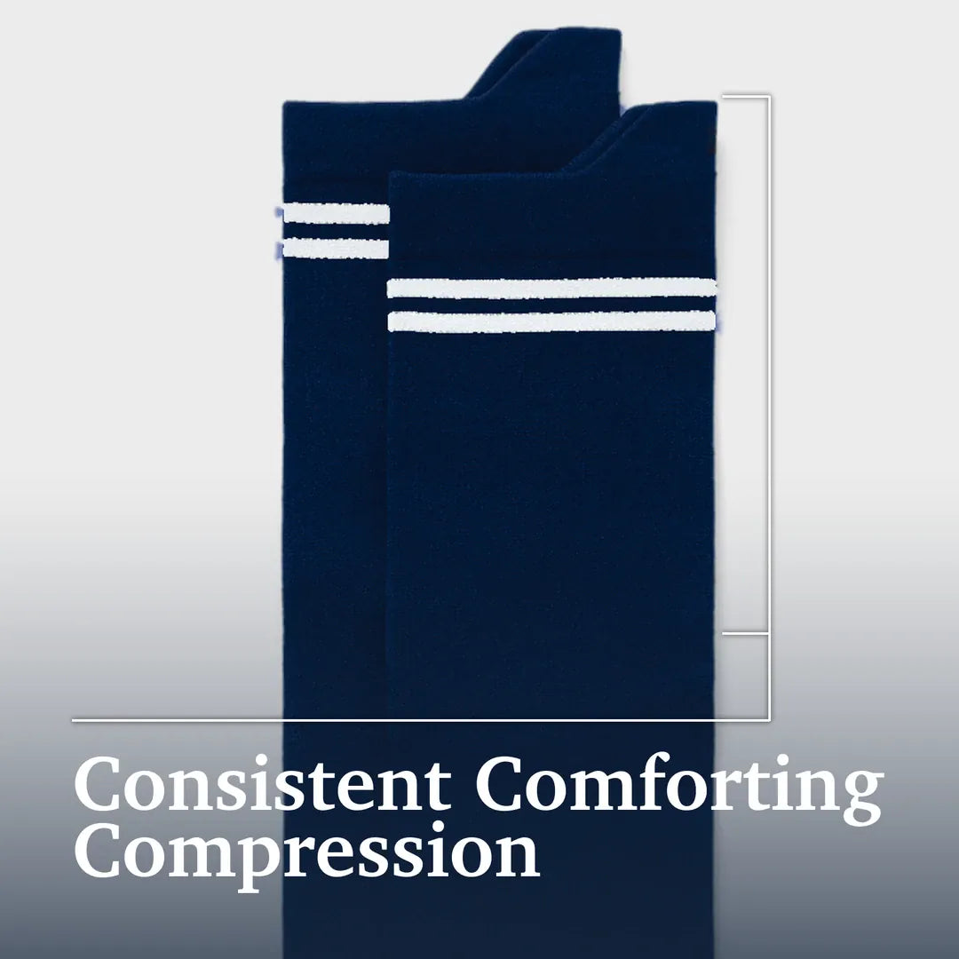 ["A pair of navy blue compression socks with white double stripes near the top, shown against a light gray gradient background with the text 'Consistent Comforting Compression' at the bottom.Joe & Bella Pink / REG Big-Grip No-Slip Compression Socks: 3-Pack ", "Dark Navy"]