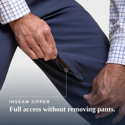 Close-up of a person's hands demonstrating the inside zippered inseam of navy pants, with text overlay reading 'INSEAM ZIPPER Full access without removing pants.'. Joe & Bella CareZips® Men's Access Pants #Dark Navy