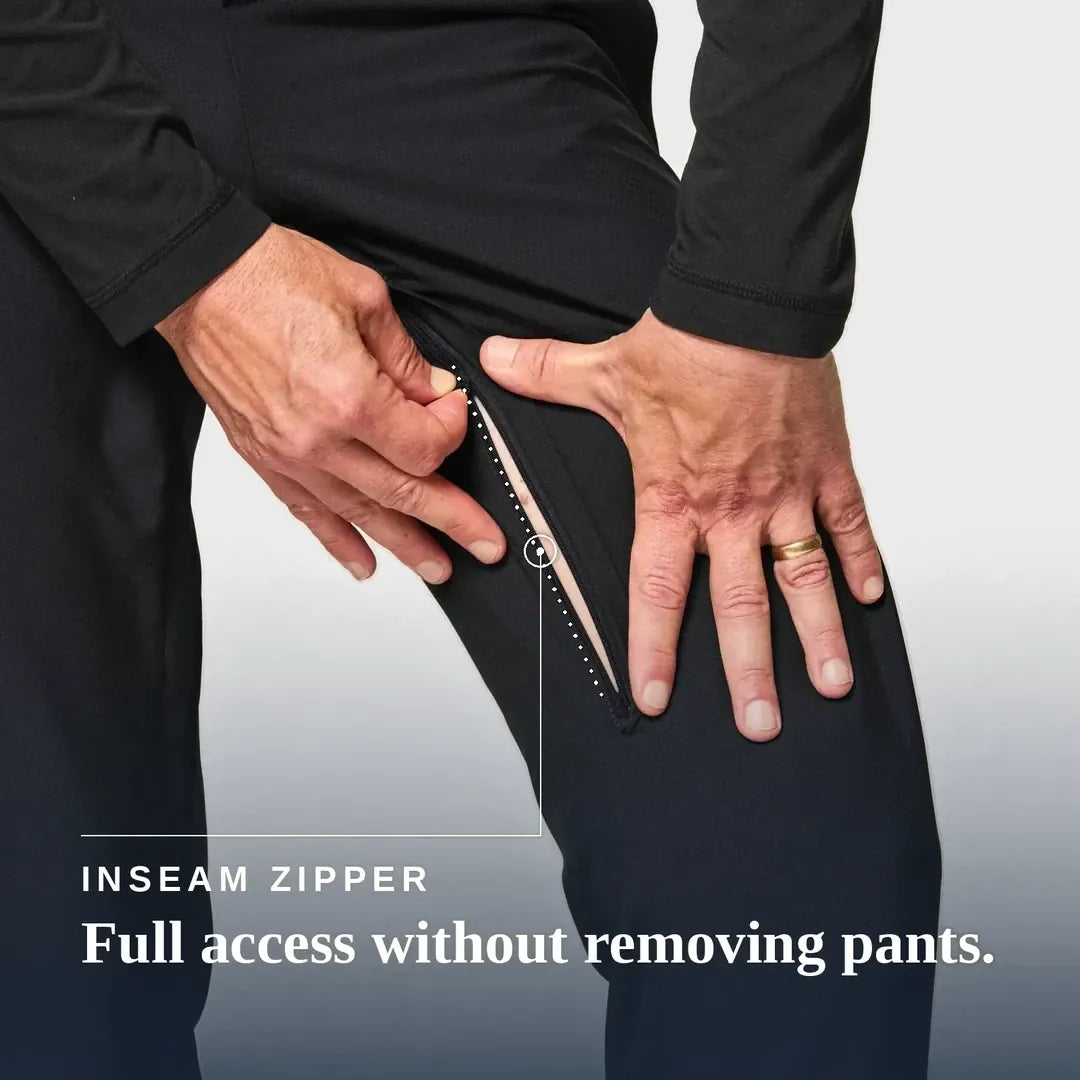 ["Close-up of a person wearing black pants and pulling open an inseam zipper with both hands, with text reading 'INSEAM ZIPPER' and 'Full access without removing pants.'. Joe & Bella CareZips® Men's Adaptive Pants ", "Black"]