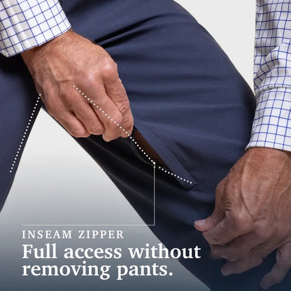 Close-up of a person's hands demonstrating the inside zippered inseam of navy pants, with text overlay reading 'INSEAM ZIPPER Full access without removing pants.'. Joe & Bella CareZips® Men's Access Pants #Dark Navy