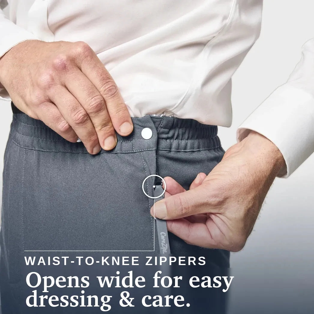 ["Close-up of a person wearing dark gray zippered pants, demonstrating a waist-to-knee zipper with a white shirt. Text on the image reads 'WAIST-TO-KNEE ZIPPERS' and 'Opens wide for easy dressing & care. Joe & Bella CareZips® Men's Access Pants ", "Slate Grey"]