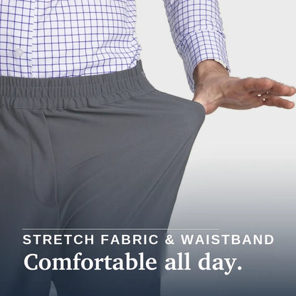 A close-up of a person wearing gray elastic-waist pants, pulling the fabric outward with one hand to demonstrate stretch. The person is also wearing a blue and white checkered shirt. Joe & Bella CareZips® Men's Access Pants #Slate Grey