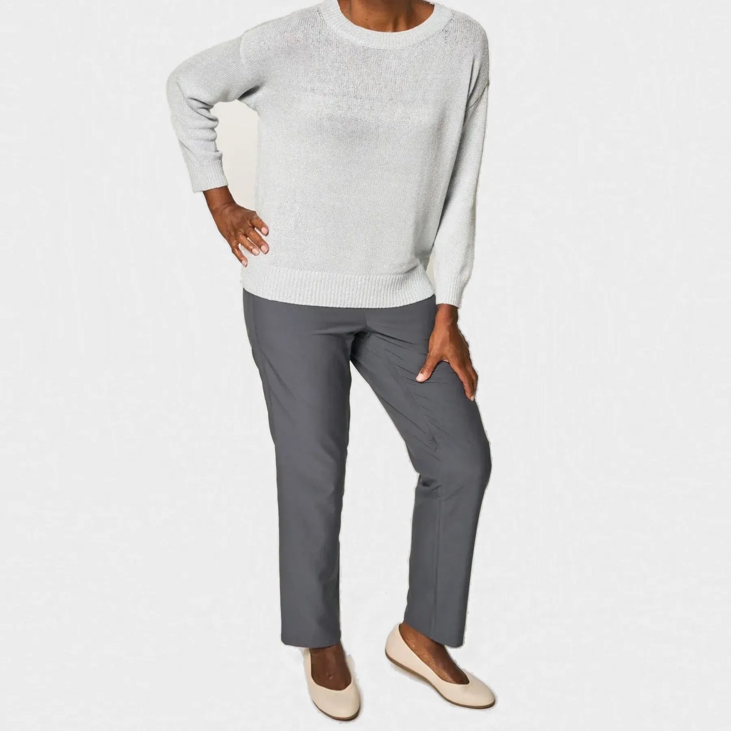 A woman modeling a light gray knit sweater and dark gray straight-leg pants with beige flats, shown against a plain white studio background. Joe & Bella CareZips® Women's Adaptive Pants #Grey