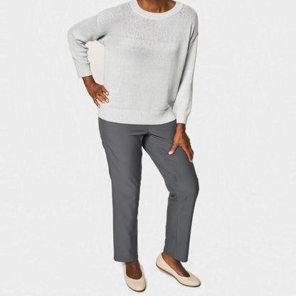 A woman modeling a light gray knit sweater and dark gray straight-leg pants with beige flats, shown against a plain white studio background. Joe & Bella CareZips® Women's Adaptive Pants #Grey