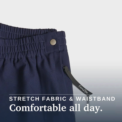 Close-up of navy blue pants showing the elastic waistband with a metal button, a drawstring detail, and text overlay that reads 'STRETCH FABRIC & WAISTBAND Comfortable all day.'. Joe & Bella CareZips® Women's Access Pants #Navy
