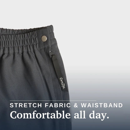Close-up of dark charcoal gray athletic pants showing the elastic waistband with a metal snap button and a fabric drawstring tag. White text at the bottom reads 'STRETCH FABRIC & WAISTBAND' and 'Comfortable all day. Joe & Bella CareZips® Women's Access Pants #Grey