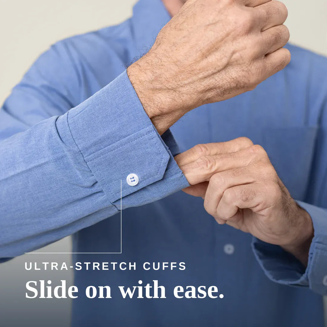 Close-up of a person wearing a blue long-sleeve dress shirt and stretching the cuff with one hand while pulling the buttoned cuff with the other. White text at the bottom reads 'ULTRA-STRETCH CUFFS Slide on with ease. Joe & Bella Everyday Magnetic Button-Down for Men | Tailored-Fit #Heathered Blue