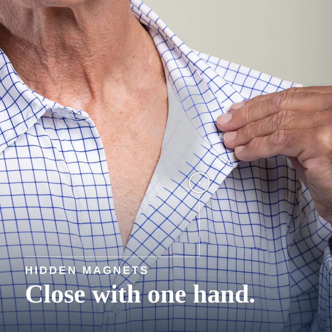 ["Close-up of a person wearing a white button-up shirt with a blue grid pattern, opening the collar with one hand. White text at the bottom reads 'HIDDEN MAGNETS Close with one hand. Joe & Bella Everyday Magnetic Button-Down for Men | Tailored-Fit ", "White Check"]
