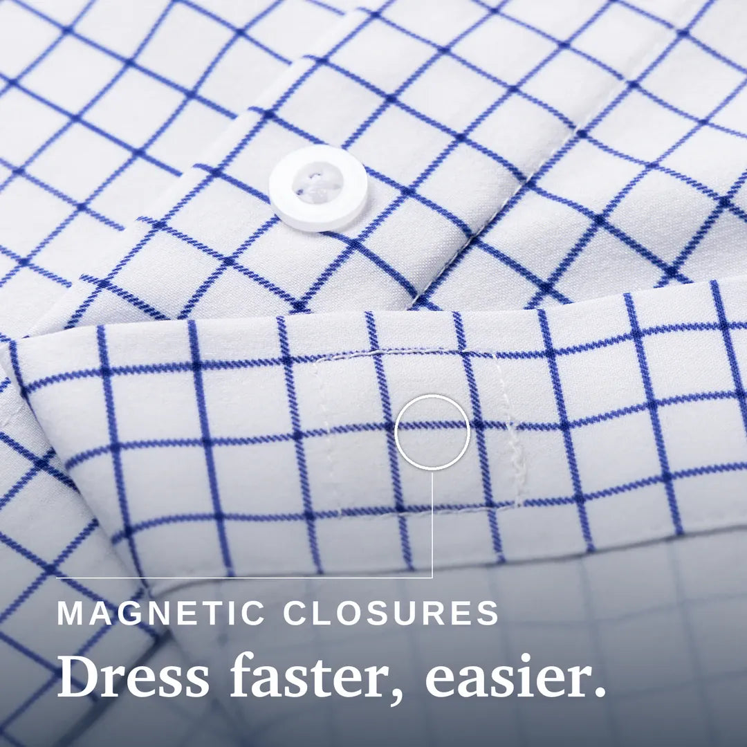 Close-up of a white fabric garment with a blue grid pattern, showing a button closure and text reading 'MAGNETIC CLOSURES Dress faster, easier.'. Joe & Bella Everyday Magnetic Button-Down for Men | Tailored-Fit #White Check