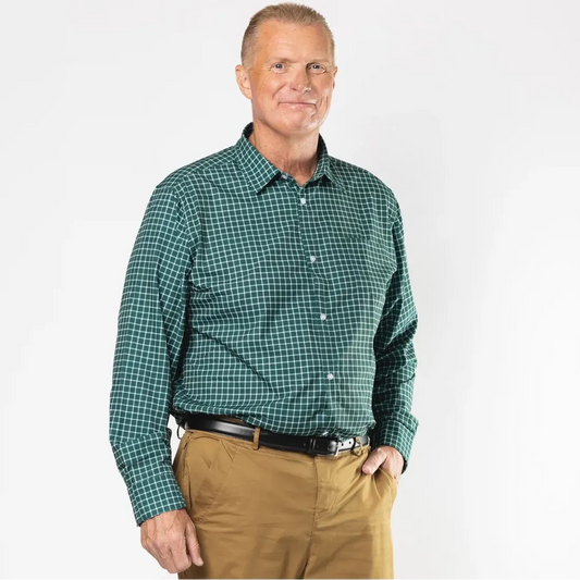 A man standing against a light gray studio background wearing a green and black checkered long-sleeve button-down shirt, tan pants, a black belt, and black sneakers. Joe & Bella Green Check / S Magnetic Button-Down for Men | Relaxed-Fit #Green Check