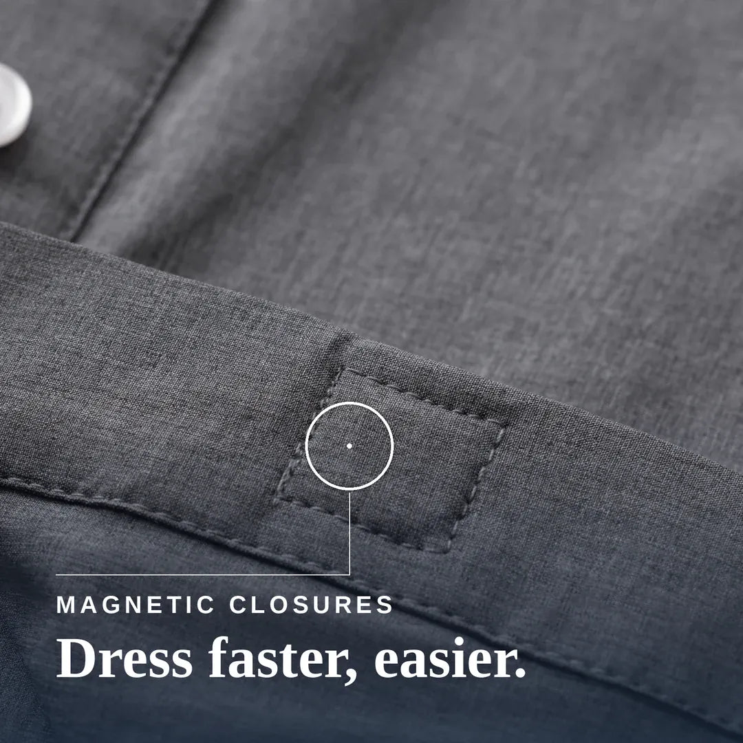 ["Close-up of a dark gray textured fabric garment showing a stitched pocket or tab with a circular callout and the text 'MAGNETIC CLOSURES Dress faster, easier.'. Joe & Bella Everyday Magnetic Button-Down for Men | Relaxed-Fit ", "Heathered Grey"]