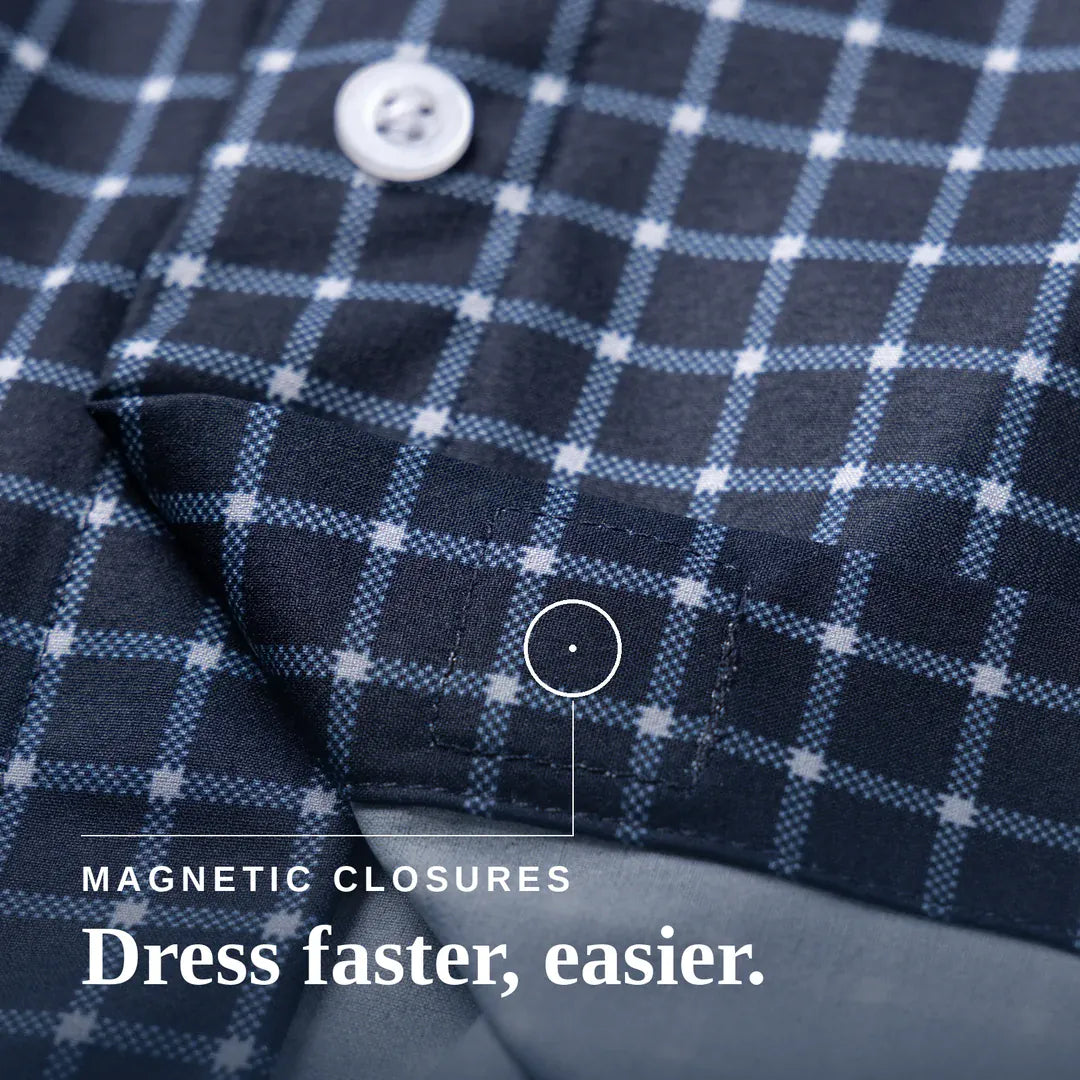Close-up of a navy and light blue plaid shirt fabric with a white button and text reading 'MAGNETIC CLOSURES Dress faster, easier.'. Joe & Bella Everyday Magnetic Button-Down for Men | Relaxed-Fit #Navy Check