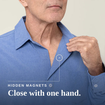 A close-up of a man wearing a blue button-down shirt, with his hand adjusting the collar and a graphic callout pointing to a hidden magnet feature. Text on the image reads 'HIDDEN MAGNETS' and 'Close with one hand. Joe & Bella Everyday Magnetic Button-Down for Men | Relaxed-Fit #Heathered Blue