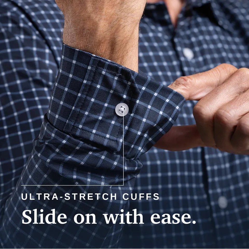 Close-up of a man wearing a navy and white checkered shirt, demonstrating the stretch of the cuff by sliding his hand inside the buttoned cuff. White text at the bottom reads 'ULTRA-STRETCH CUFFS Slide on with ease. Joe & Bella Everyday Magnetic Button-Down for Men | Relaxed-Fit #Navy Check