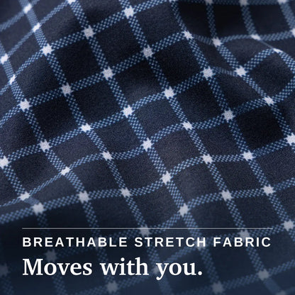 Close-up of a navy plaid fabric with white and light blue grid lines and text reading 'BREATHABLE STRETCH FABRIC Moves with you.'. Joe & Bella Everyday Magnetic Button-Down for Men | Relaxed-Fit #Navy Check