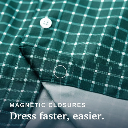 Close-up of a green and white plaid button-up shirt with a folded cuff showing a gray inner lining and magnetic closure detail, with text reading 'MAGNETIC CLOSURES Dress faster, easier.'. Joe & Bella Everyday Magnetic Button-Down for Men | Relaxed-Fit#Green Check