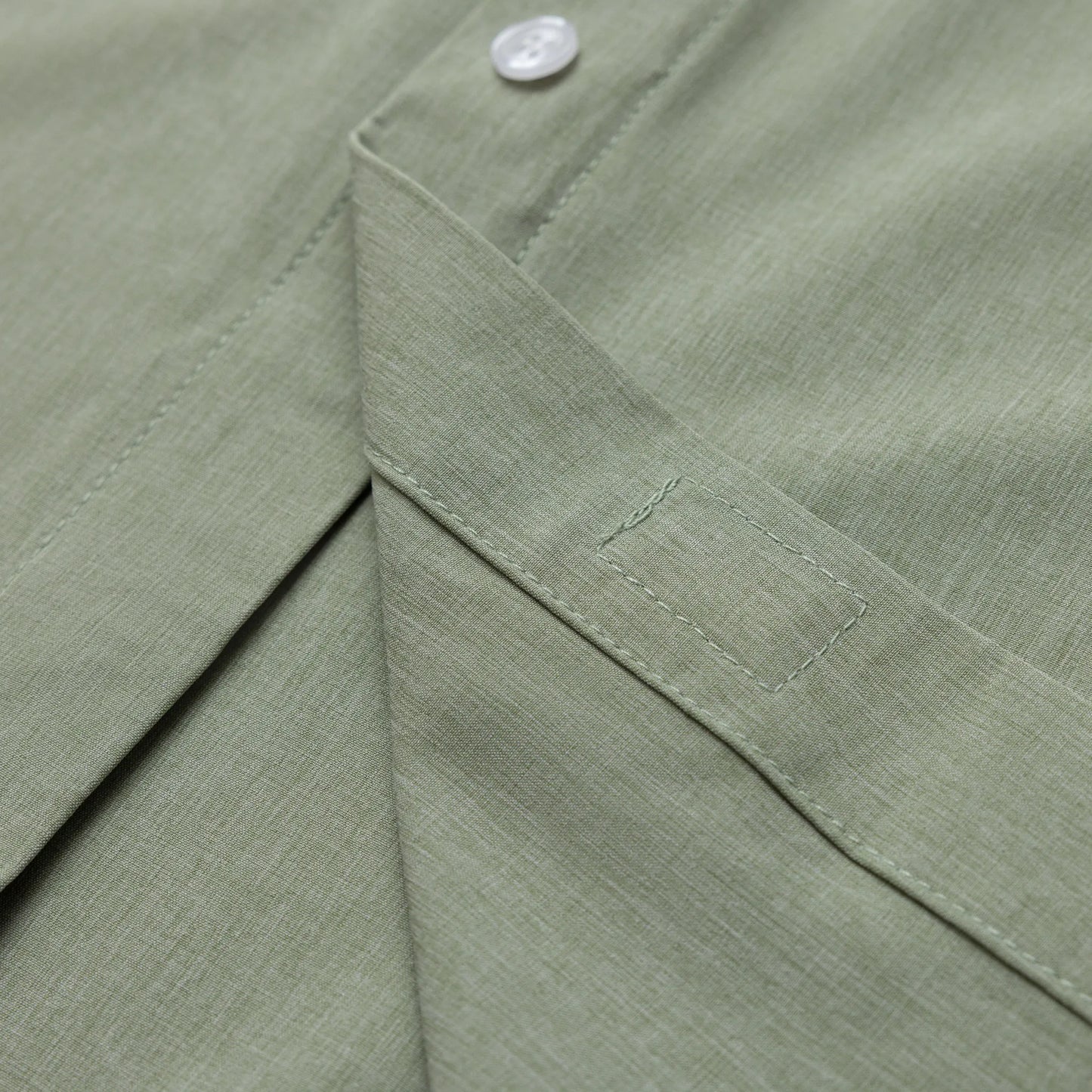 Close-up of a green fabric with a button detail #Green