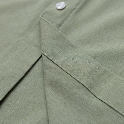 Close-up of a green fabric with a button detail #Green