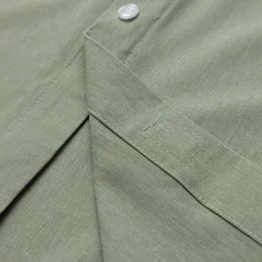 Close-up of a green fabric with a button detail #Green