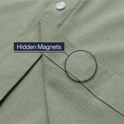 Close-up of a green shirt with a button and text indicating 'Hidden Magnets'. #Green