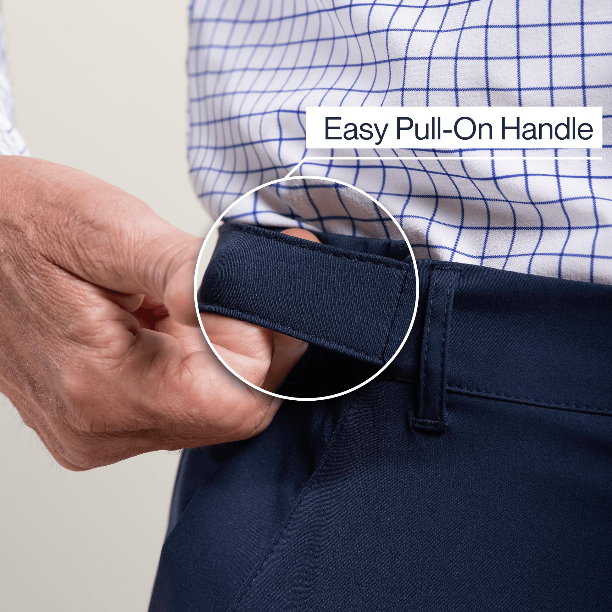 ["Person adjusting navy pants with an easy pull-on handle, wearing a checkered shirt. ", "Navy"]