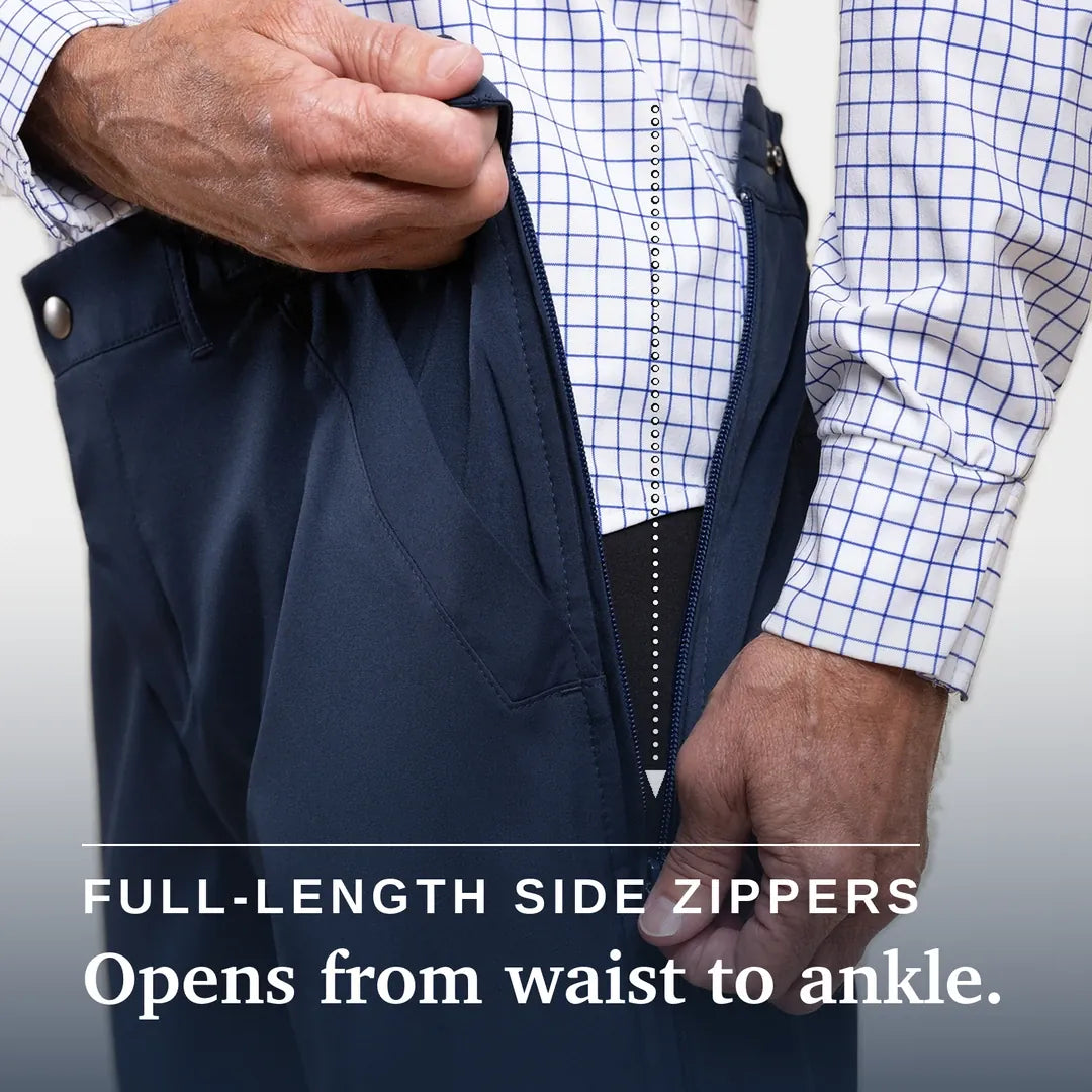 ["Close-up of a person wearing dark navy pants and a white dress shirt with a blue grid pattern, demonstrating a full-length side zipper that opens from the waist to the ankle. Text overlay reads 'FULL-LENGTH SIDE ZIPPERS Opens from waist to ankle. ", "Navy"]