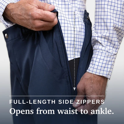 Close-up of a person wearing dark navy pants and a white dress shirt with a blue grid pattern, demonstrating a full-length side zipper that opens from the waist to the ankle. Text overlay reads 'FULL-LENGTH SIDE ZIPPERS Opens from waist to ankle. #Navy